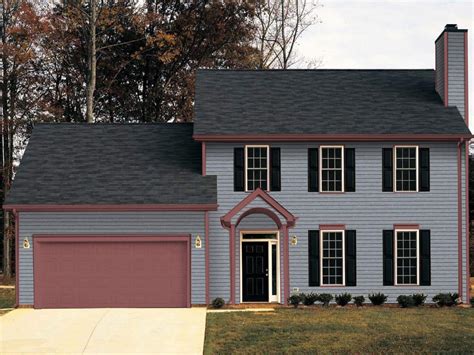 black metal roof on grey house|dark grey brick house.